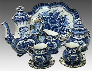 A Russian painted Gzhel teaset consisting of a teapot, teacups, saucers and a serving tray