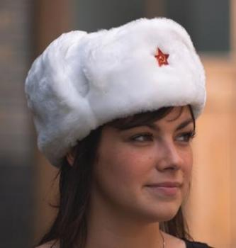 A Russian woman wearing a white Ushanka fur hat